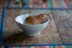 a pear, a white bowl